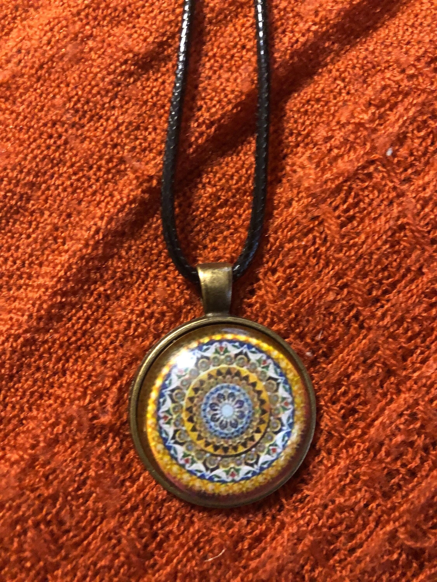 Golden Bohemian pendant with black satin cord necklace